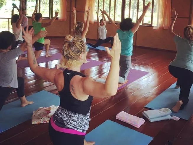 Group yoga class in a wooden studio
