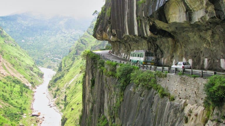 white van on road near cliff during daytime