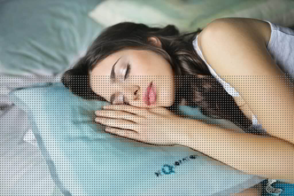 woman sleeping on blue throw pillow