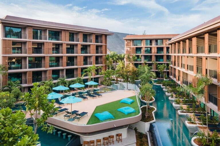 Modern hotel with pool and lounge area.