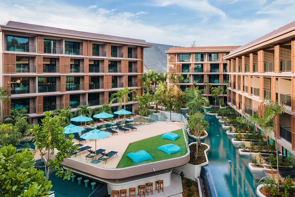 Modern hotel with pool and lounge area.