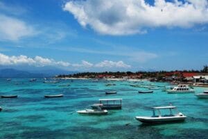 Turquoise bay with small boats and coastal village