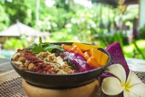 Colorful tropical smoothie bowl with fresh fruit toppings