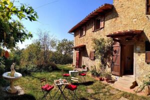 Rustic stone house with garden patio seating
