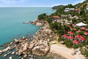 Cliffside tropical resort overlooking turquoise ocean bay