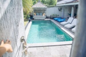 Private courtyard pool with lounge chairs and cabana