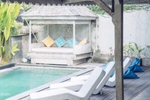 Backyard pool with lounge chairs and shaded daybed