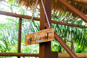 Wooden yoga in process sign hanging outdoors