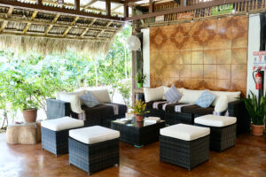 Tropical outdoor lounge with wicker sofas and plants