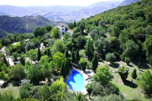 Aerial view of hillside villa with pool