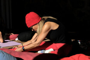 Woman stretching on yoga mat in sunlight