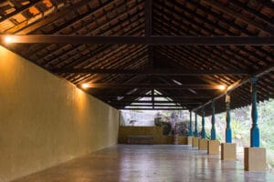 Open-air pavilion with wooden beams and blue columns