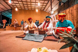 Traditional musicians playing instruments in rustic indoor setting