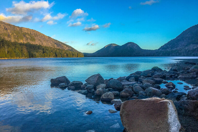 Rocky shoreline along calm mountain lake