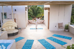 Woman practicing yoga on tropical terrace