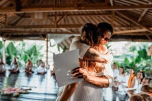 Couple hugging during ceremony in open-air pavilion