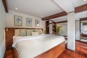 Modern bedroom with wooden floors and large bed