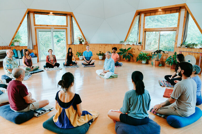 Group meditation session in bright yoga studio