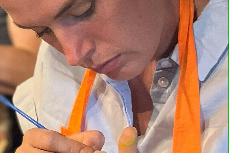 Close-up of woman painting with fine brush