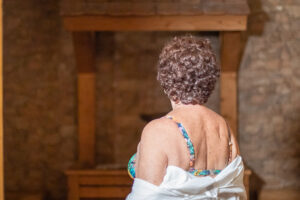 Woman in swimsuit before wooden church cross