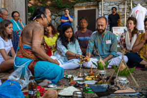 Group participating in outdoor Hindu ritual ceremony