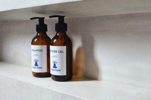Amber shampoo and shower gel bottles on shelf
