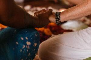 Two people holding hands in warm indoor setting