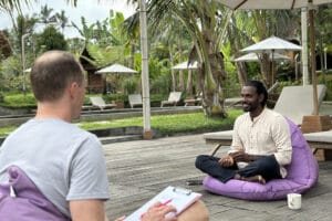 Two men talking at tropical outdoor resort
