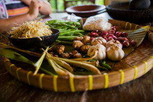 Fresh vegetables and spices on woven tray