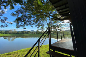 Wooden deck overlooking calm lake and mountains