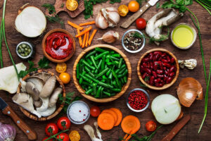 Fresh vegetables and beans on wooden table
