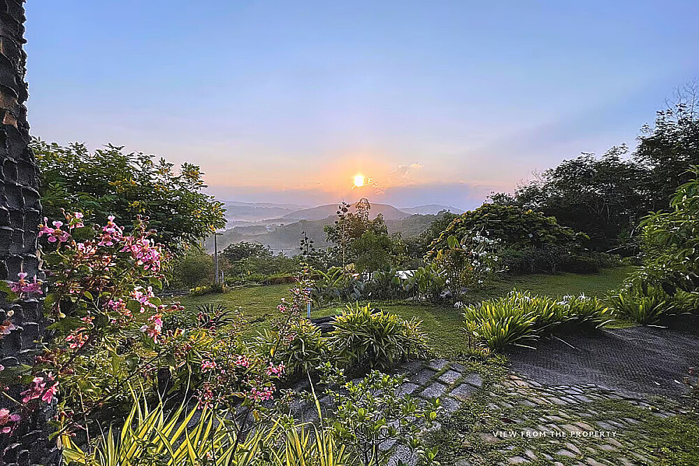 Sunrise over misty mountains and lush garden