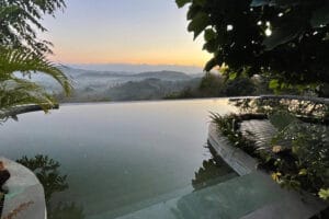 Infinity pool overlooking misty mountain sunrise