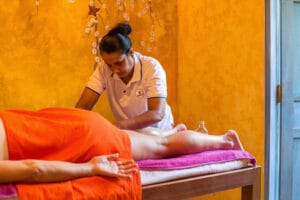 Woman giving leg massage in spa setting