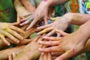 Colorful painted hands joined together in circle