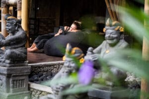 Woman relaxing on beanbag using smartphone outdoors