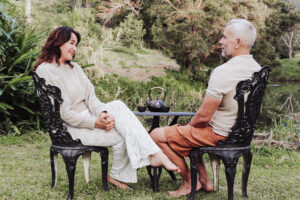 Couple enjoying tea in lush garden setting