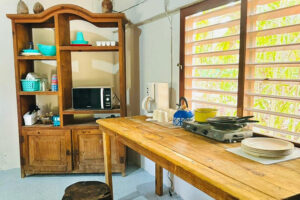 Rustic wooden kitchen with open shelves and table