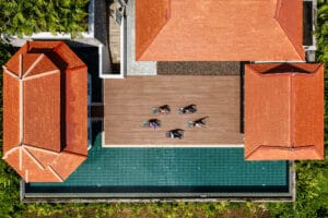 Aerial view of rooftop yoga by pool