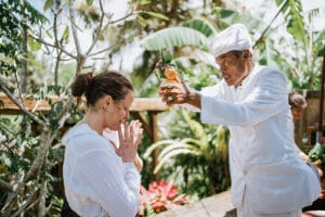 Man performing traditional blessing ceremony outdoors