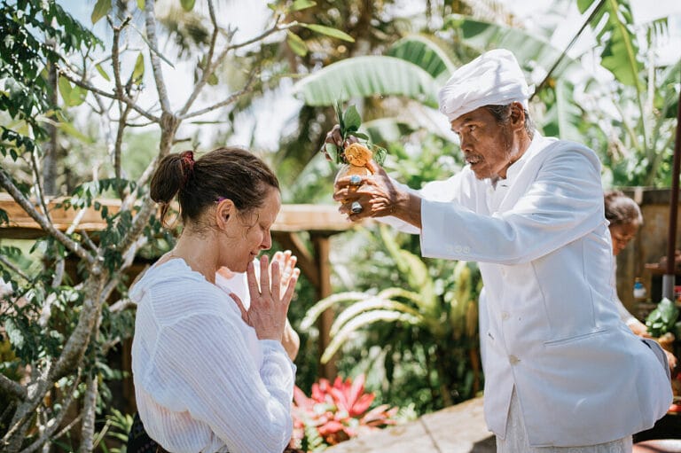 Man performing traditional blessing ceremony outdoors