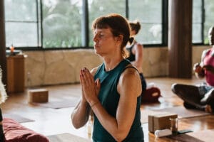 Woman practicing yoga in sunlit studio