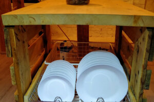 Stacked white plates in wooden kitchen cart