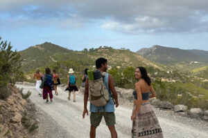 Group of hikers on mountain trail overlooking hills