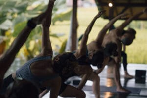 Group practicing yoga in open-air studio