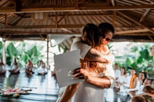 Couple embracing during ceremony in tropical pavilion