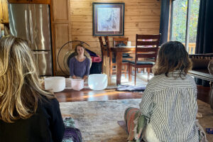 Woman leading sound meditation with crystal singing bowls