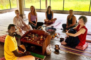 Group seated around small ritual altar indoors