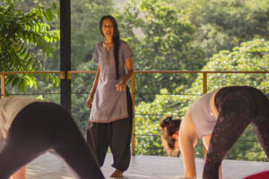 Yoga instructor guiding students in outdoor pavilion