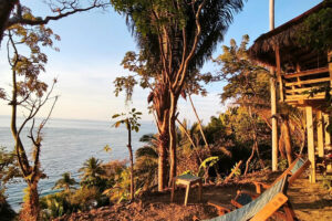 Tropical ocean view with hammock at sunset